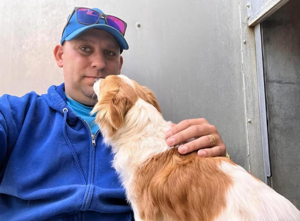 a man holding a dog